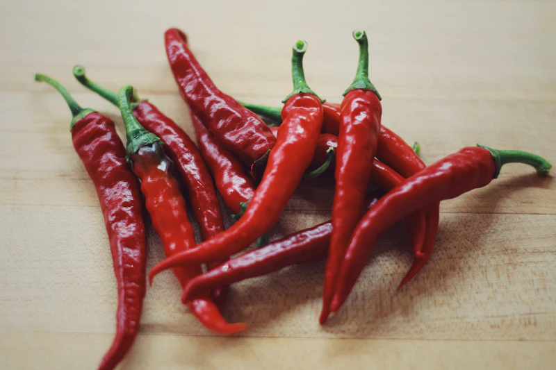 Fresh long red chillies on a wooden board