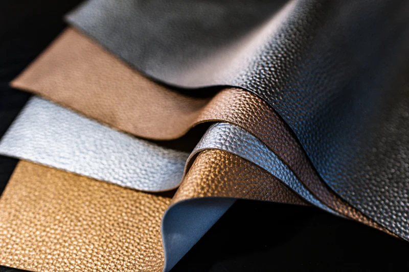 Layered sheets of finished leather in tan, grey and brown
